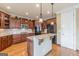 Lovely kitchen featuring an island, recessed lights, pendant lights, wood cabinets and stainless steel appliances at 217 Brunswick Dr, Tyrone, GA 30290