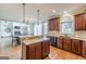 Well-designed kitchen with granite counters, stainless appliances, wood cabinetry, and center island at 217 Brunswick Dr, Tyrone, GA 30290