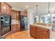 Spacious kitchen with wood cabinets, granite counters, stainless steel appliances, and a center island at 217 Brunswick Dr, Tyrone, GA 30290