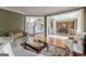 A sunlit living room with hardwood floors, open to dining room and staircase at 217 Brunswick Dr, Tyrone, GA 30290