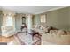 Inviting living room showcasing elegant furnishings, a patterned rug, and soft natural light through draped windows at 217 Brunswick Dr, Tyrone, GA 30290