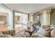 Cozy living room featuring hardwood floors, crown molding, and comfortable seating at 217 Brunswick Dr, Tyrone, GA 30290