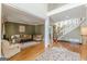 Bright living room with hardwood floors, a fireplace, and a view of the staircase at 217 Brunswick Dr, Tyrone, GA 30290