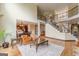 Bright living room featuring a fireplace, open staircase, and views into the dining area at 217 Brunswick Dr, Tyrone, GA 30290