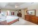 Luxurious primary bedroom featuring tray ceiling, wood furniture, and plush carpeting throughout at 217 Brunswick Dr, Tyrone, GA 30290