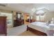 Spacious primary bedroom featuring elegant wood furniture, tray ceiling, large windows, and plush carpeting at 217 Brunswick Dr, Tyrone, GA 30290