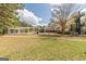 Community pool with a large slide, sun shelter, and a large white home in the background at 217 Brunswick Dr, Tyrone, GA 30290