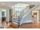Beautiful staircase with decorative iron railings and a large window offering natural light at 217 Brunswick Dr, Tyrone, GA 30290