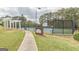 Community tennis courts surrounded by a fence and trees; with Racquet Club sign at 217 Brunswick Dr, Tyrone, GA 30290
