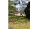 Spacious backyard with a mix of grassy areas and trees, offering a serene outdoor setting at 1079 Pine Ne St, Conyers, GA 30012
