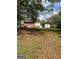 Lush backyard with mature trees surrounding the home for privacy and shade at 1079 Pine Ne St, Conyers, GA 30012