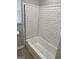 A tiled tub and shower combination in this bathroom at 1079 Pine Ne St, Conyers, GA 30012