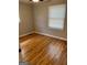 Inviting bedroom featuring hardwood floors, a ceiling fan, and natural light from the window at 1079 Pine Ne St, Conyers, GA 30012