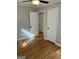 This bedroom features hardwood floors, gray walls and a ceiling fan at 1079 Pine Ne St, Conyers, GA 30012