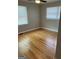 Comfortable bedroom with hardwood floors, fresh paint, and a window offering views at 1079 Pine Ne St, Conyers, GA 30012