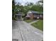 Exterior view of a brick house with a paved driveway leading to a carport at 1079 Pine Ne St, Conyers, GA 30012