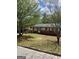 Charming brick home featuring a covered carport and a well-maintained front yard with mature trees at 1079 Pine Ne St, Conyers, GA 30012