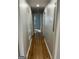 View down a hallway featuring hardwood floors and doorways at 1079 Pine Ne St, Conyers, GA 30012
