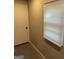 Hallway leading to an exterior door, showcasing a window and the adjacent wall at 1079 Pine Ne St, Conyers, GA 30012