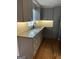 This kitchen features granite counters, tile backsplash and gray cabinets at 1079 Pine Ne St, Conyers, GA 30012