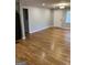 Bright living room featuring hardwood floors, fresh paint, and recessed lighting at 1079 Pine Ne St, Conyers, GA 30012