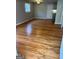 Open living room boasting gleaming hardwood floors, a ceiling light, and a fresh coat of neutral paint at 1079 Pine Ne St, Conyers, GA 30012