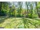 Serene backyard with lush greenery, mature trees, and plenty of space for recreation at 3614 Fairburn Nw Pl, Atlanta, GA 30331