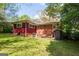 Expansive backyard featuring a well-maintained lawn, patio area, and mature trees at 3614 Fairburn Nw Pl, Atlanta, GA 30331