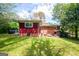 Lush backyard with a red brick house, mature trees, and a well-maintained lawn at 3614 Fairburn Nw Pl, Atlanta, GA 30331