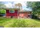 View of backyard with a green lawn, mature trees and a brick exterior at 3614 Fairburn Nw Pl, Atlanta, GA 30331