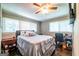 Spacious bedroom with a ceiling fan, ample windows, and warm lighting at 3614 Fairburn Nw Pl, Atlanta, GA 30331