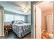 Cozy bedroom featuring a ceiling fan, windows and ensuite bathroom at 3614 Fairburn Nw Pl, Atlanta, GA 30331