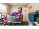 Bedroom with dark hard wood flooring, a crib and toys at 3614 Fairburn Nw Pl, Atlanta, GA 30331