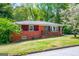 Charming red-brick home with well-manicured front lawn and mature trees at 3614 Fairburn Nw Pl, Atlanta, GA 30331