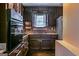 View of a kitchen equipped with brown cabinets, a cooktop, and stainless steel appliances at 3614 Fairburn Nw Pl, Atlanta, GA 30331