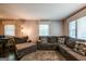 Comfortable living room with large sectional couch, and two large windows at 3614 Fairburn Nw Pl, Atlanta, GA 30331