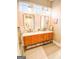 Bright bathroom with marble countertop, double vanity and warm wood drawers at 11297 Serenbe Ln, Palmetto, GA 30268