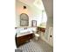 Charming bathroom with a marble-topped vanity, black and white tiled floors, and a stylish mirror at 11297 Serenbe Ln, Palmetto, GA 30268