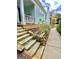 Charming light-blue home featuring a stone walkway leading to a covered porch at 11297 Serenbe Ln, Palmetto, GA 30268