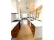 Modern kitchen featuring stainless steel appliances, an island, and hardwood floors at 11297 Serenbe Ln, Palmetto, GA 30268