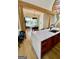 Spacious kitchen island with wooden cabinets and an adjacent dining area filled with natural light at 11297 Serenbe Ln, Palmetto, GA 30268