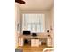 Well-lit home office with custom built-in desk, storage, and a modern window shade at 11297 Serenbe Ln, Palmetto, GA 30268