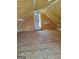 An attic space with plywood walls and floors featuring a door and an air conditioner unit at 5003 Samantha Ct, Mcdonough, GA 30252