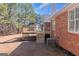 Brick home with wooden deck, stairs, and an HVAC system in a well-maintained backyard at 5003 Samantha Ct, Mcdonough, GA 30252
