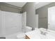 Clean bathroom featuring a shower-tub combo, white fixtures, and a vanity sink at 5003 Samantha Ct, Mcdonough, GA 30252