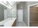 Bathroom with double vanity, large mirror, neutral tile and walk in closet through white door at 5003 Samantha Ct, Mcdonough, GA 30252