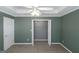 Bedroom featuring open closet, carpet, neutral walls, ceiling fan and a large window at 5003 Samantha Ct, Mcdonough, GA 30252