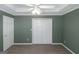 Neutral bedroom featuring a ceiling fan, carpet flooring, closet, and paneled door at 5003 Samantha Ct, Mcdonough, GA 30252