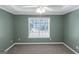 Spacious bedroom featuring a ceiling fan, carpet flooring, and a window with natural light at 5003 Samantha Ct, Mcdonough, GA 30252
