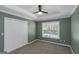 Bedroom with ceiling fan and ample natural light from a large window at 5003 Samantha Ct, Mcdonough, GA 30252